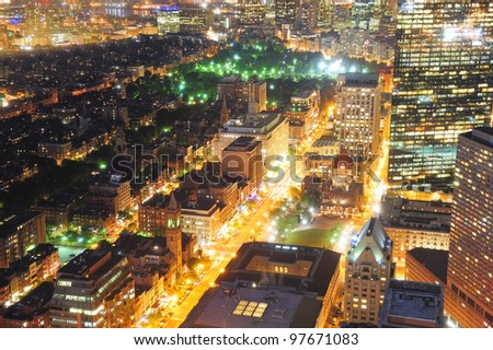 Urban city night scene. Boston aerial view with skyscrapers at night with city skyline illuminated.