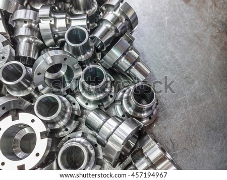 Shiny steel parts after cnc turning, drilling and machining on steel surface selective focus close-up composition background.