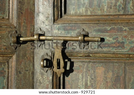Antique sliding door lock on weathered door