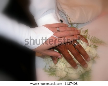 Hands of a Black and White couple getting married