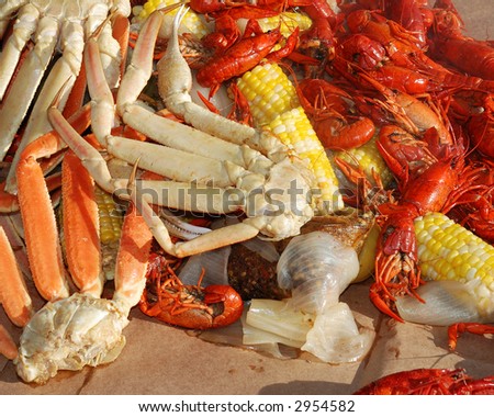 A seafood medley of steaming crab legs, crayfish and vegetables
