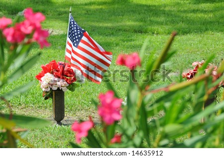United States flag marking loss of military with flowers.