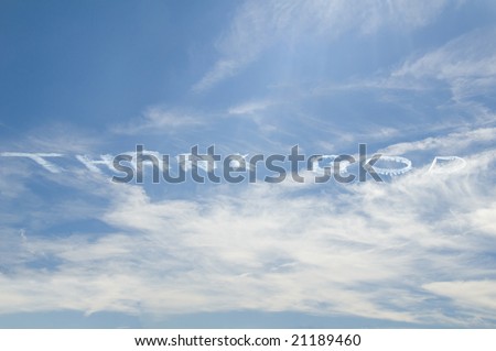 Thank God written in the sky by an airplane with blue sky on a partially cloudy day