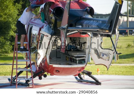 ST. CLOUD, FL - APRIL 13: An unidentified person works on the Orlando Regional Healthcare Helicopter as it waits for a emergency call at St. Cloud Hospital on April 13, 2009 in St. Cloud. Florida.
