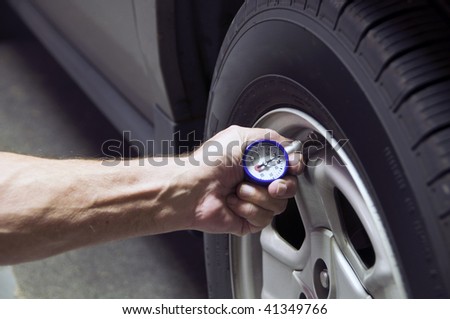 Mechanic checking tire pressure for increased gas mileage