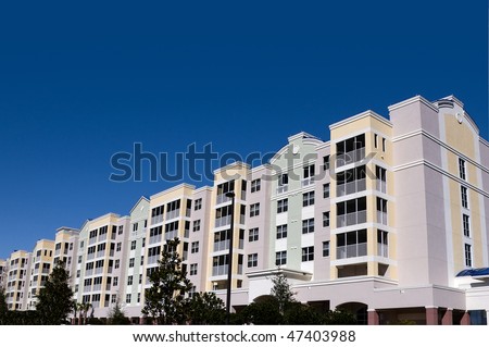 High contrast multi colored high rise condominiums with individual balconys and large area for text