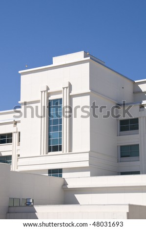 Exterior of hospital with tinted windows and blue sky