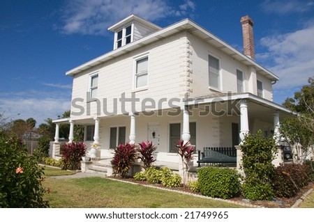 historical home with unique porch pillars with blue sky stock photo