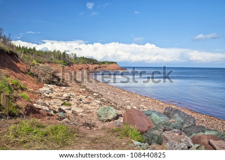A rocky sandstone beach in a rural area of eastern Prince Edward Island, Canada.