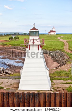 Two lighthouse located at Wood Islands, Prince Edward Island, Canada.  One on the wharf and a distant one on the bluff.