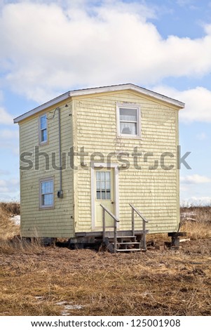 An old yellow house in a rural location.