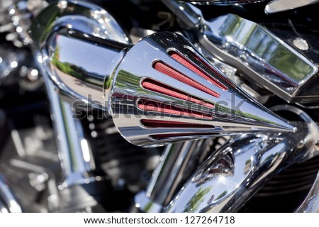 A motorcycle chrome breather used to improve engine performance.  A breather works with the air filter to hold down some of the dust and moisture entering the engine.