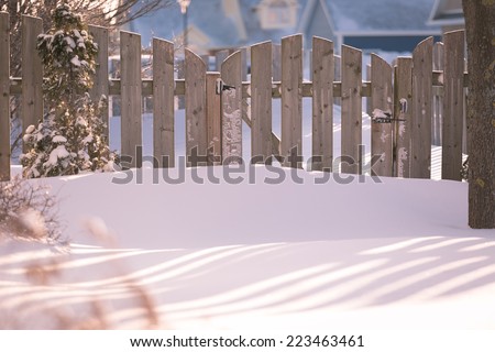 Garden gate of a suburban garden buried in snow.