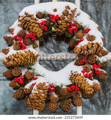 Christmas cone wreath covered in snow