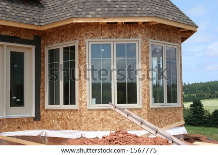 The exterior of a partially constructed house showing the new windows.