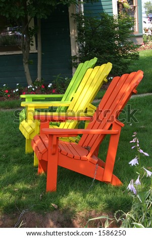 Colorful lawn chairs sitting in the shade.