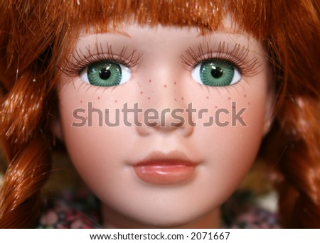 stock photo Red haired porcelain doll with vivid green eyes