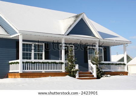 A view of a new home in winter, covered with snow.