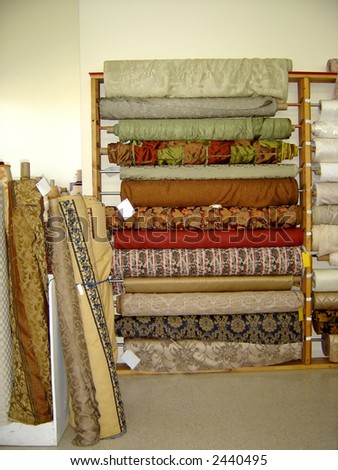 A variety of bolts of fabric on display.