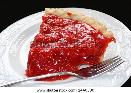 A favorite spring pie, strawberry chiffon pie on a white serving plate with fork.