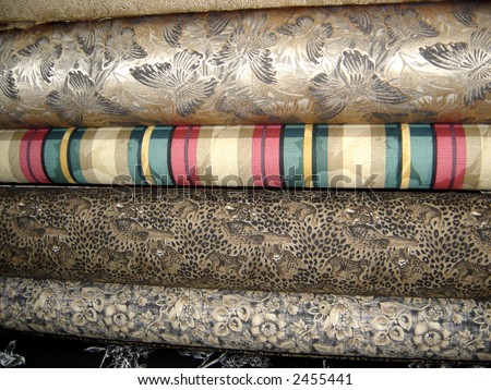 A variety of different bolts of fabric.