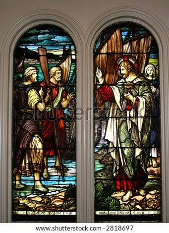Stained glass windows showing the Biblical story of Jesus and the disciples and the fish.