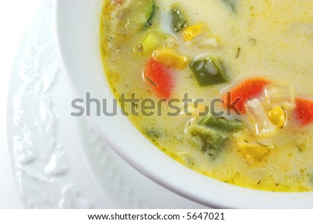 A bowl of homemade soup with lots of vegetables.