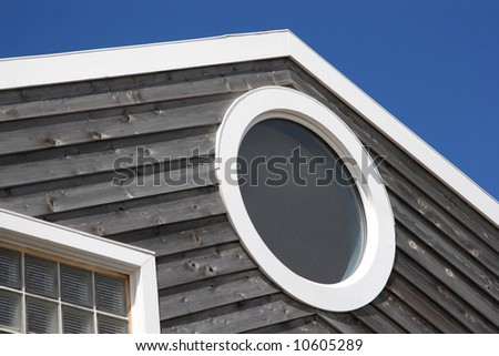 A round window at the top of a home.