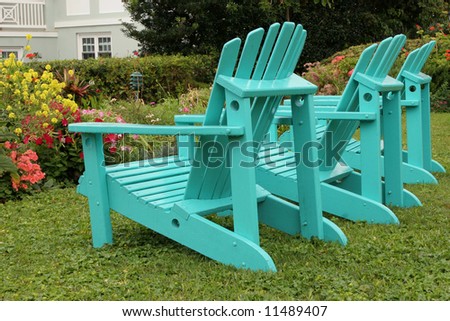 Turquoise lawn chairs in the summer garden.
