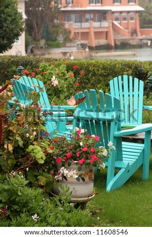 Rain falling on turquoise lawn chairs in a Bermuda garden.
