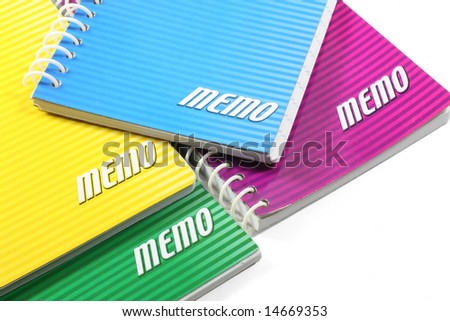 Assorted colors of ringed paper memo pads.