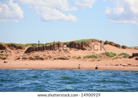 Along the north shore of Prince Edward Island are many areas of sand dunes and beaches frequented by sun bathers.