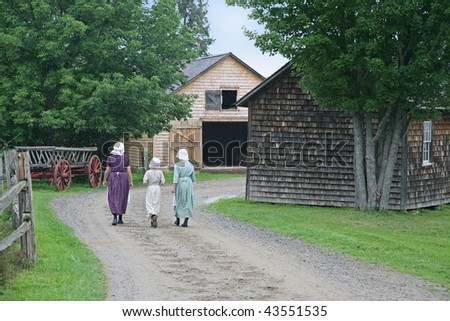Pioneer village re-enactment with people in period costume.