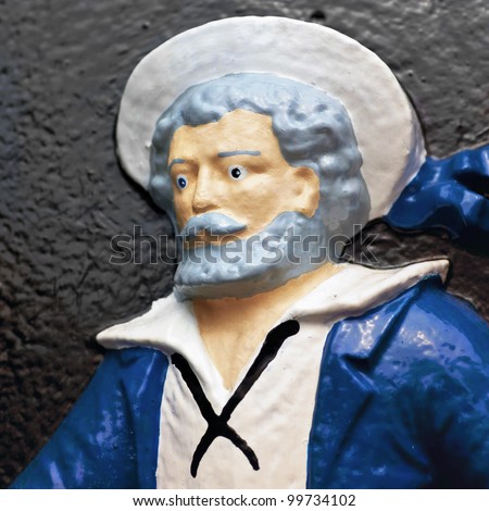 A painted figure of a sailor on a cast iron plaque.  Plaque is found in the Halifax Public Gardens in Halifax, Nova Scotia, Canada.