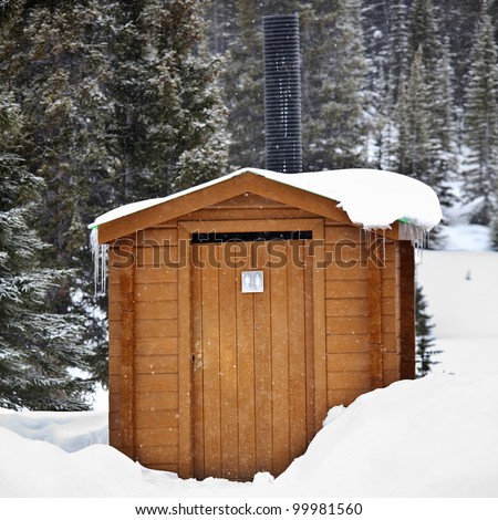 Outside toilet covered in snow in Jasper National Park, Alberta, Canada.