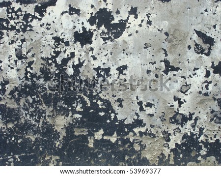 worn gray black painted wall with paint chip crack and blathering