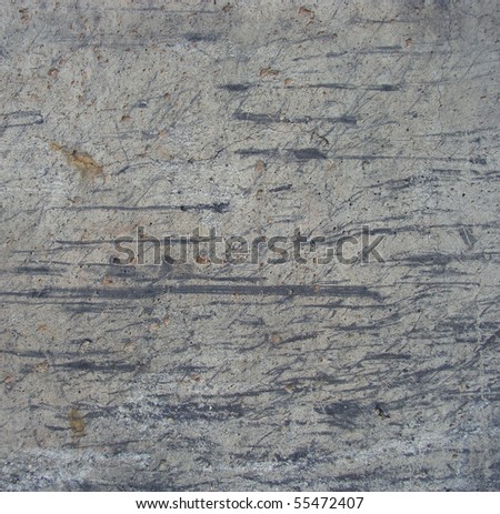 gray industrial concrete wall with marks from rubber