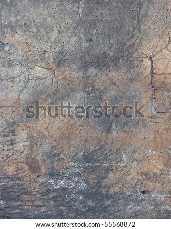 flamed color dirty worn concrete wall with cracks and rubber mark