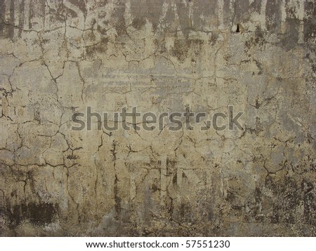 old dirty worn wall with old advertising fonts still showing