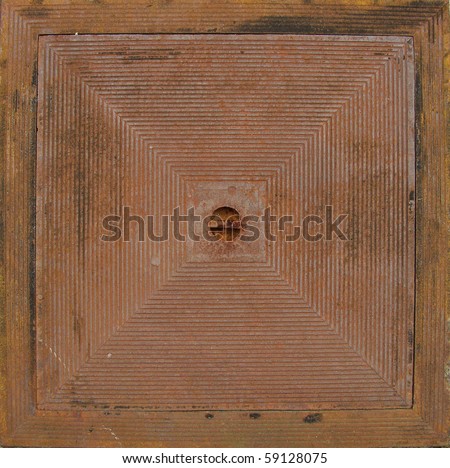 rusty metal square shaped seal for a sewer pit