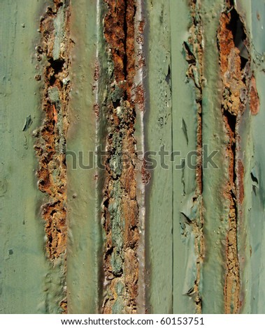 detail of a very rusty green metal fence