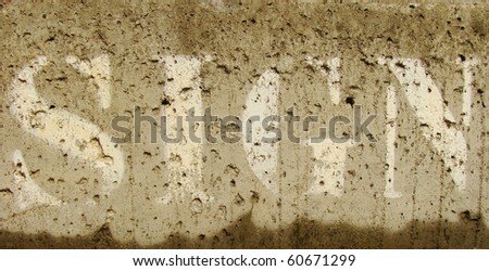 the word sign sprayed on moist concrete