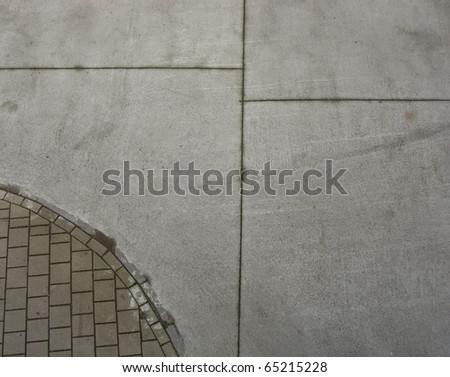 circular sidewalk and concrete pavement seen from top