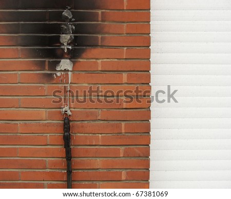short circuit fire damage on a brick wall