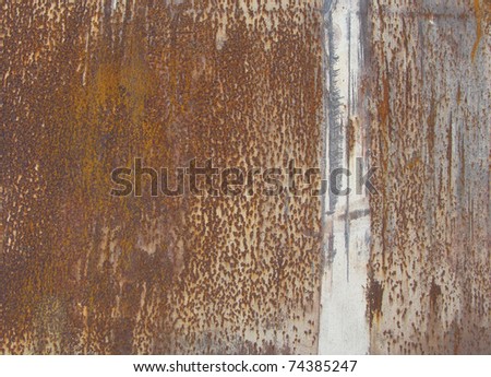 orange brown rusty metal surface with a white line running vertically