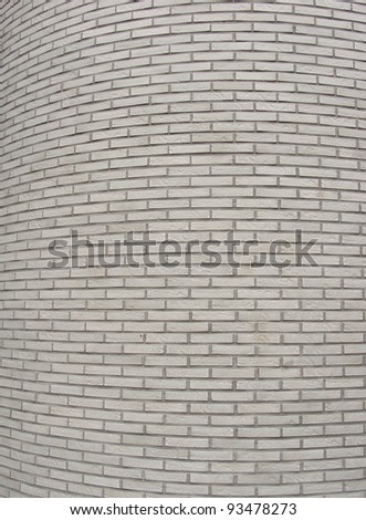rounded corner of a large white tiled wall