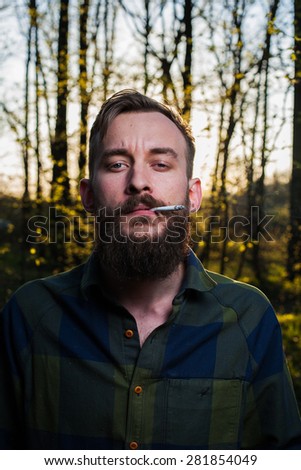 men hipster beard  lumber jack wood forest axe