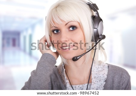 The young girl in ear-phones with a microphone, a communications service provider