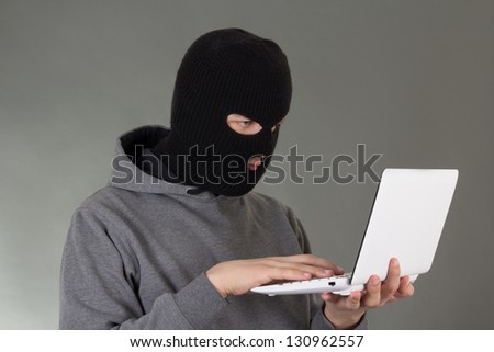 hacker stealing data from white notebook