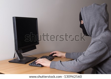 hacker in mask with personal computer